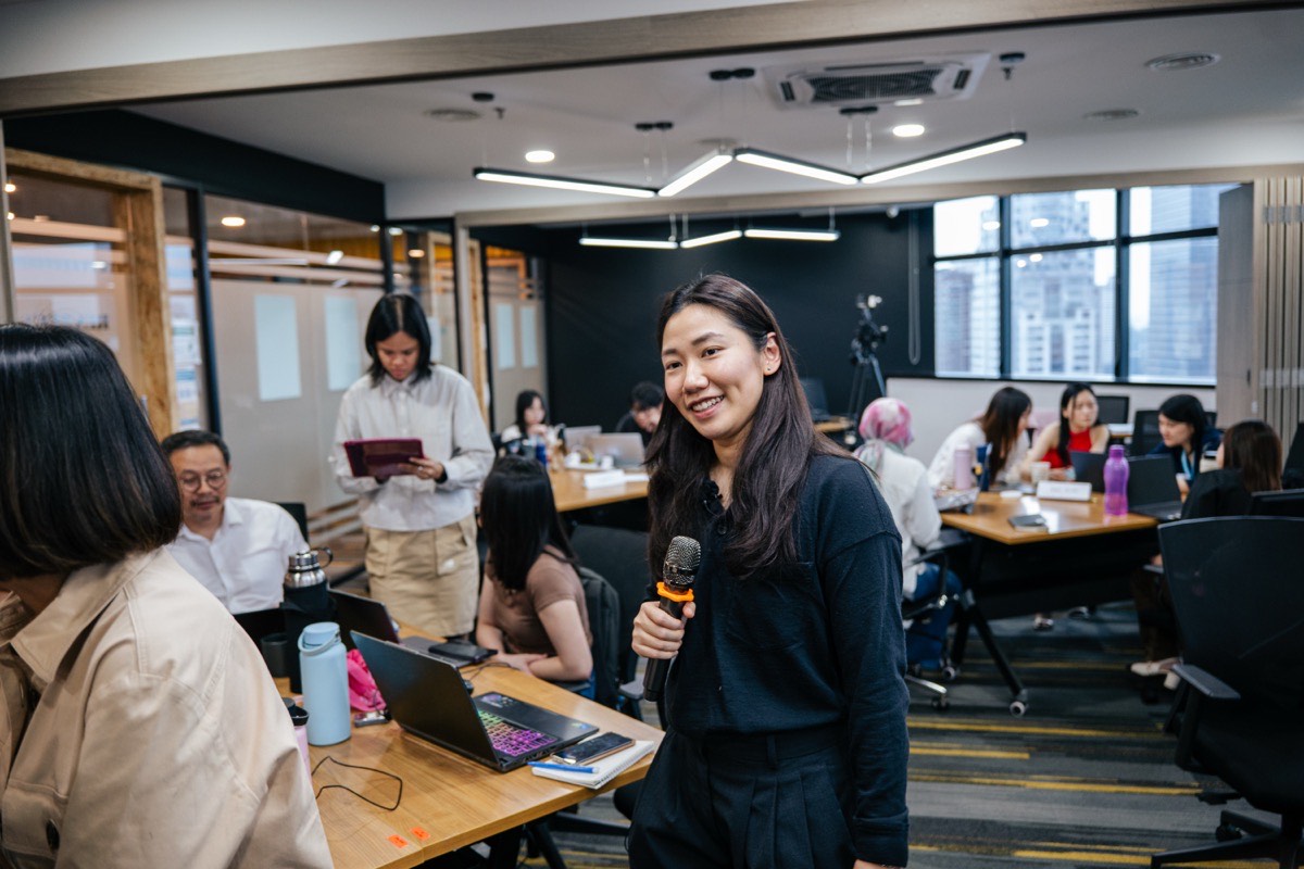 Michelle Lo Horton smiling while facilitating a Story ARC™ workshop with the full room engaged